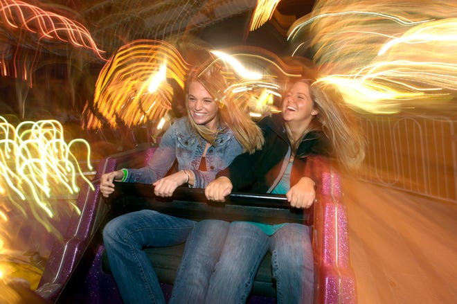 Britney Annunziato, 16, left, and Eden Keener, 18, right, take a spin on the Matterhorn ride at the Coastal Empire Fair on Thursday. Hunter McRae/Savannah Morning News