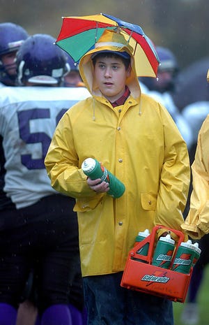 Valley Tech waterboy Peter Mayer, 13, was well protected against the rain during Saturday's game against Keefe Tech in Framingham.
