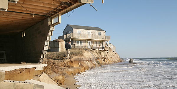 The Madaket area on the western end of Nantucket took a severe beating from Noel’s gales on Saturday. Chunks of the home in the foreground tumbled into the sea, while the storm’s force ate away at the foundation of the house at right, leaving it alarmingly vulnerable to wind and wave.