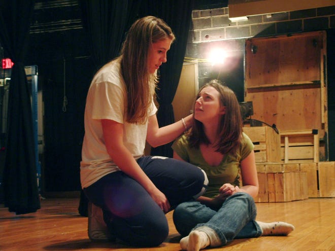 Hamilton-Wenham Regional High School student Kate Chamberlin consoles Shelley played by student Christina Brown in ‘Bat Boy the Musical.’