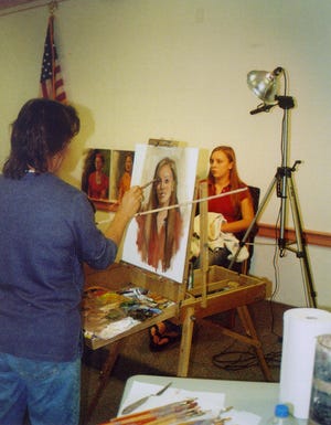 Diane Miller is painting the portrait of Shannon Donnelly. The West Roxbury Art Association meets monthly at the West Roxbury Branch Library.