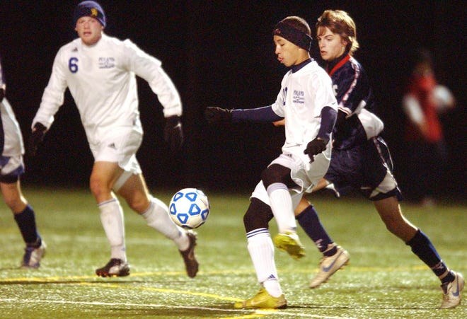 Poland's Dean Agen, center, dribbles the ball in front of Cherry Valley-Springfield's Chip Taylor, right, in a state regional boys soccer playoff game,Friday at Herkimer County Community College's Wehrum Stadium in Herkimer. At left is Poland's Brett Darrow.