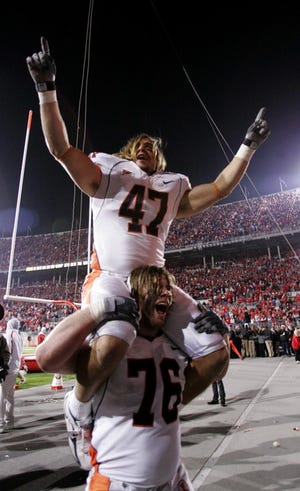 Illinois' Jeremy Leman (top) and Mike Ware celebrate after the Illini beat No. 1 Ohio State.