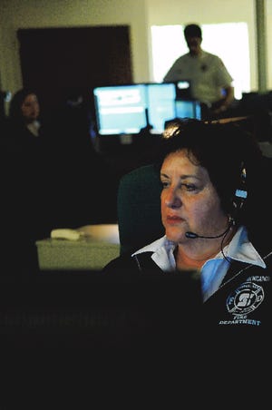 Karen Delucchi, a fire dispatcher, monitors her computer for incoming calls at the Fire Station on Sonora Avenue in Stockton.