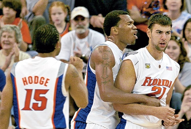 Marreese Speights congratulates Dan Werner in the Gators' 93-65 win against Tennessee Tech at the Stephen C. O'Connell Center on Sunday. (Photo by Tim Hussin/ Special to the Sun)