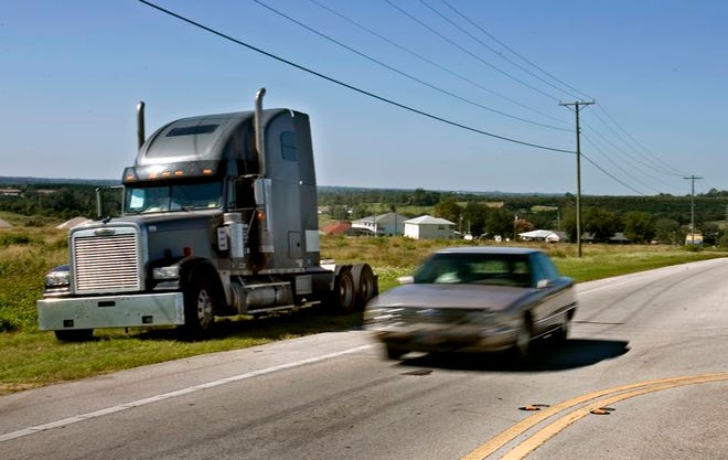 A semi truck tractor parks along State Road 17 on the south side of Dundee.