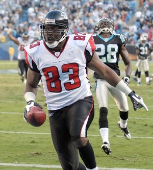 Atlanta's Alge Crumpler (83) scores the winning touchdown Sunday as Carolina's Quinton Teal reacts in disgust. Crumpler, a New Hanover High School graduate, had missed the previous two games with ankle and knee injuries.