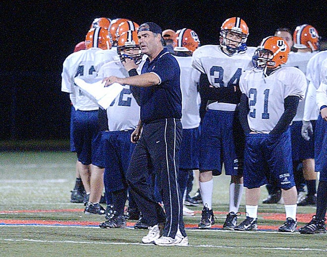 Kirk Jellerson talks to his players as Utica College football team practice under the lights at Charles A. Gaetano Stadium in Utica.