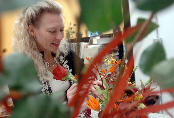 Carolyn Kegler of Carolyn Kegler Floral Designs arranges flowers at her store located at 697 Belmont St. Kegler is one of a number of female-owned and operated businesses at the address. She has been in her storefront for about a year.