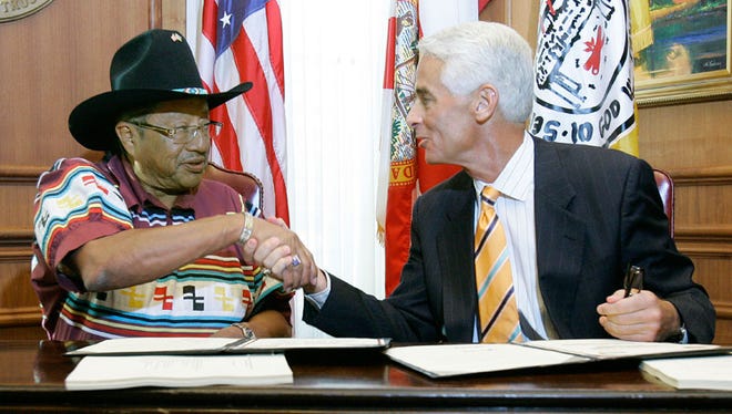 Gov. Charlie Crist, right, shakes hands with Mitchell Cypress, Chairman of the Seminole Tribe of Florida, after signing a 25-year gaming compact that has the potential to provide billions of dollars to Florida’s schools. In exchange for significant revenue sharing of profits, the agreement gives the tribe the exclusive right to operate slot machines and card games in the seven existing facilities on tribal lands in Florida.