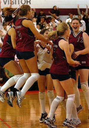 The Westborough girls volleyball team celebrates after winning the third game against Bourne for the Div. 2 state championship at Hudson High School Saturday.