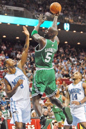 Kevin Garnett of the Celtics goes up and over Rashard Lewis of Orlando to get off a shot.