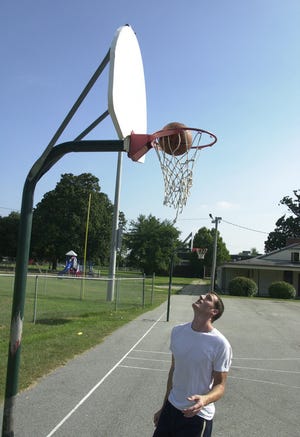 Brian Brockway shoots some hoops at May Park. The new court will be lighted and will feature a Fiberglas backboard.