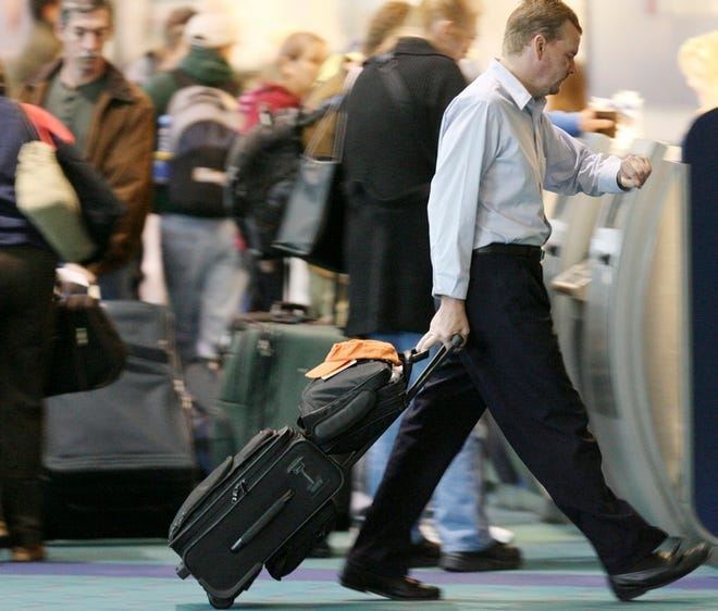 Travelers check their watches to make sure they make their connections and get home in time for Thanksgiving. On Monday, Portland International Airport in Oregon already was starting to get crowded with holiday fliers.