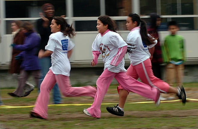 Fuller Middle School seventh graders Gleisislaine Santos , Sinath Sophal and Anna Much-Hichos race at the start of the school's first Turkey Trot Wednesday morning. Students in all three grades ran a a one mile loop around the school. The MetroWest Health Foundation provided t-shirts and snacks.
