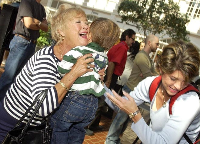 Grandmother Sylvia Gubacsi of Hilton Head Island hugs her 19-month-old grandson, Joshua Kincheloe, as he arrives with his parents, including mother Stephanie Kincheloe, at right, at Savannah/Hilton Head Interntational Airport on Tuesday. The child and his parents live in New York. (Carl Elmore/Savannah Morning News)
