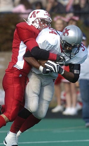 NFA's David Billings, left, tackles St. Bernard's Marquise Ruffin, right, in a game at Norwich Free Academy on Saturday, October 13, 2007.