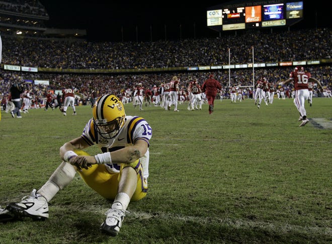 LSU quarterback Matt Flynn sits on the field after throwing an interception on a 2-point conversion attempt in the third overtime period of the 50-48 loss against Arkansas on Friday.