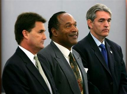 O.J. Simpson, center, is flanked by his lawyers Gabriel Grasso, right, and Yale Galanter during Simpson's arraignment in Las Vegas, Wednesday, Nov. 28, 2007. Simpson pleaded not guilty to charges of kidnapping and armed robbery of two sports memorabilia dealers.