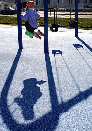 Sarah Soule, 6, of Weymouth has the swings at the Mary Jeanette Murray Bathhouse in Hull all to herself – and her shadow – on a cool but sunny day.