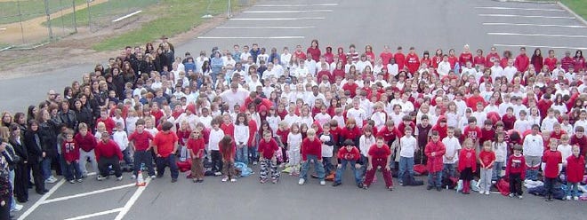 More than 550 staff and students at Barrett Elementary Center dressed in red, white and blue to form a flag to honor veterans on Friday, Nov. 9.