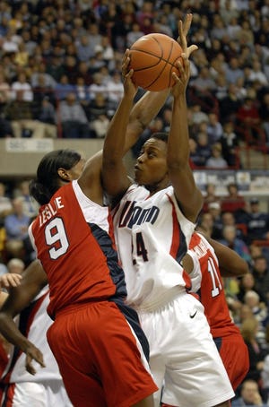 Connecticut's Charde Houston, right, is guarded by USA National Team's Lisa Leslie during the second half of an exhibition basketball game in Storrs, Conn., Friday, Nov. 2, 2007.