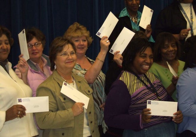Nearly 30 teachers from Cleveland Elementary School were all smiles Thursday as they received bonus checks of up to $7,900 through the Teacher Advancement Program.