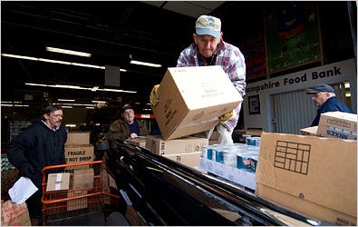 Maurice Doucet of Jerry’s Food Pantry loads up at the New Hampshire Food Bank with Steve McCarthy, left, and Mark Wallace.