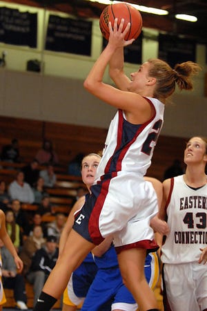 Eastern's Nicky Morey, center, goes up for a basket as Roger Williams' Heather Babin, left, watches during a game at Eastern Connecticut State University in Willimantic on November 29, 2007.