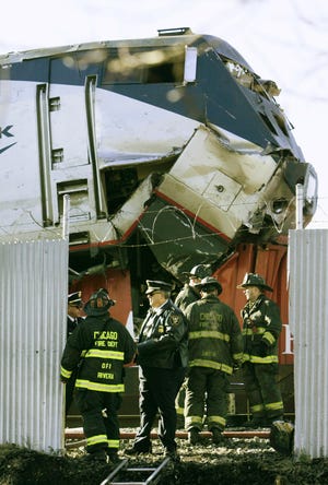 Chicago firefighters work Nov. 30 around the scene where an Amtrak passenger train plowed into the back of a freight train on the Chicago's South Side.