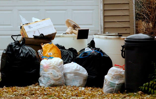 A pile of garbage sitting along the driveway at 4336 Kennett Ave. has been there for months.