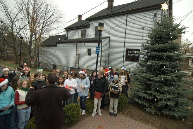 The Braintree South Middle School Chorus performs during the tree lighting ceremony at the Thayer Public Library.