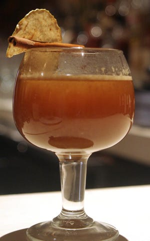 A warm glass of Michael Waterhouse's Hot Mulled Cider with cloves, cinnamon and bourbon gives off an inviting aroma.