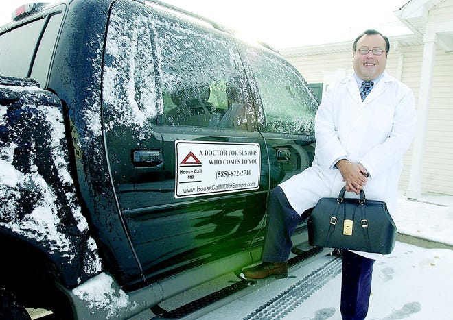Dr. Luis G. Postigo stands next to his truck at his Webster residence. Postigo has started Senior Medical Care, a new type of medical practice in the Webster area. He provides house calls to his patients, who are all 65 years or older.