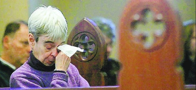 A woman grieves at a ceremony Thursday for the victims of the Westroads Mall shooting in Omaha, Neb. Six of the dead were store employees; two were customers.
