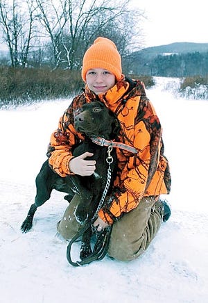 Angel Ridall, 16, of Naples, poses with Molly, a German short-hair pointer, one of two dogs she uses when she serves as a guide for pheasant hunters.