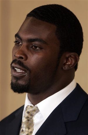 Michael Vick makes a statement after pleading guilty to a federal dogfighting charge in Richmond, Va., in this Aug. 27, 2007 file photo. Vick awaits a judge's ruling Monday, Dec. 10, 2007, on how long he will remain in prison for his role in a dogfighting conspiracy.