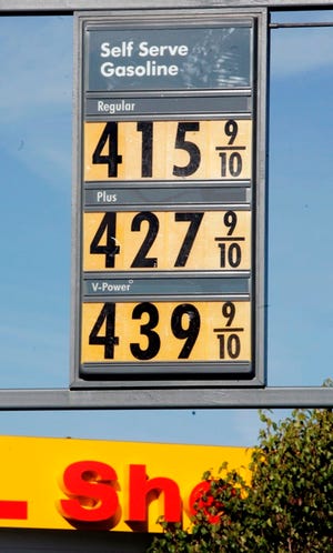 High gas prices are posted Wednesday, Nov. 14, at a Shell gas station in San Mateo, Calif. Gas prices are within striking distance of May’s record national average of $3.227 a gallon.