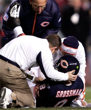 Chicago quarterback Rex Grossman lays on the ground after being injured against Washington on Thursday.
