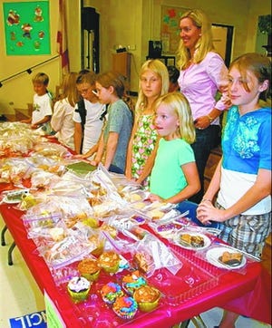 Student council members at Lakeview Elementary School wrap up the school's annual family dinner night Oct. 25 with a sweet finale of fall-themed cupcakes, cookies and assorted baked goods for purchase. The event was catered by Cosimo's restaurant.
 CORRESPONDENT
 PHOTOS / 
 KATIE FLATH