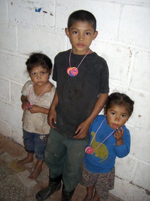 These three children were the first to see the arrival of the medical team to the mountains above Comayagua, Honduras. They then ran through the village, spreading the word to residents that there would be a clinic at the village school. For his work, Framingham Police Lt. Patricia Grigas gave the young boy a pair of soccer cleats, donated by school children in Framingham.