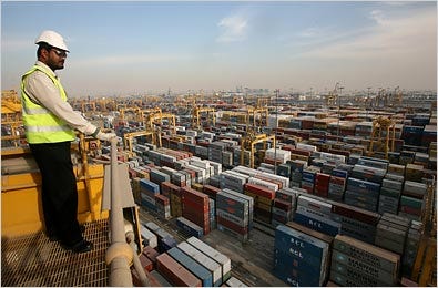 A safety inspector looks over containers alongside the Jebel Ali Free Zone, the oldest and largest free trade zone in Dubai, United Arab Emirates.