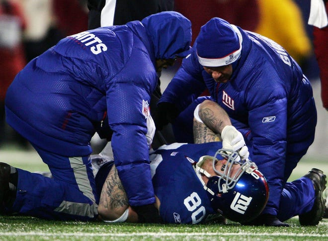EAST RUTHERFORD, NJ - DECEMBER 16: Jeremy Shockey #80 of the New York Giants is tended to on the field after getting injured in the third quarter against the Washington Redskins at Giants Stadium on December 16, 2007 in East Rutherford, New Jersey. (Photo by Chris McGrath/Getty Images)