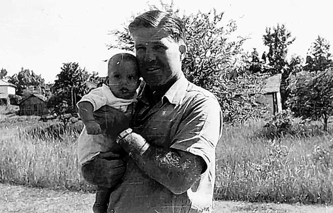 YORK TIMES
 George Romney holds his infant son, Mitt, in a 1947 family photo. On the campaign trail, his father's ghost hovers constantly over GOP presidential candidate Mitt Romney.