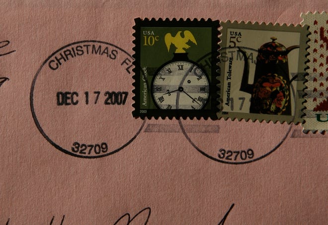 The postmark, sought after by people mailing their holiday cards at the post office in Christmas is seen here Monday. Christmas' four full-time postal workers can't keep up by handstamping the letters, so they are now shipped under special arrangement to a clearinghouse, where the coveted postmark is applied.