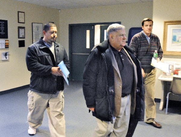 Wampanoag tribe chairman Shawn Hendricks, left, the tribe’s lawyer, William McDermott, center, and Mashpee’s assistant town manager, Rene Reed, enter a meeting where the town and the tribe are negotiating co-existence issues.