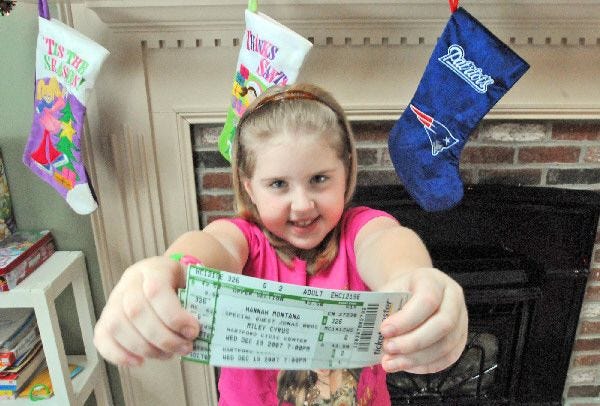Ashley James holds her Hannah Montana tickets that she won. She was headed to the concert last night.