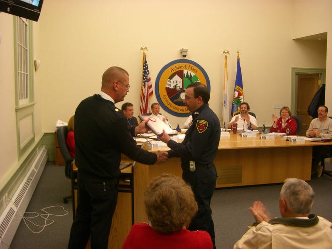 Ashland Fire Chief Bill Kee, left, presents firefighter/EMT Bob Gemma with the Firefighter of the Year award at last night's selectmen meeting.