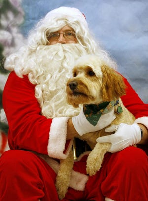 Santa Claus takes a holiday photo with Bella Dec. 20, 2007, at Petco on East State Street in Rockford. Bruce Solko, who played Santa, said he has been visited by all kinds of pets, from dogs and cats to snakes and bugs.