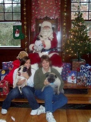 Sharon and Jessie Clarke, of Carver, visited with Santa, who is a huge pug fanatic, this year,
